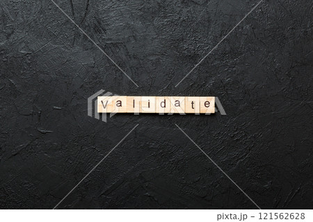 VALIDATE word written on wood block. VALIDATE text on cement table for your desing, concept 121562628