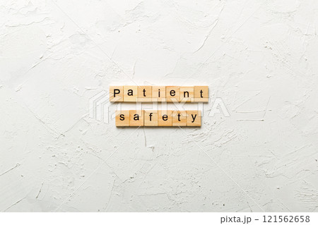 Patient Safety word written on wood block. Patient Safety text on cement table for your desing, concept Patient Safety word written on wood block. Patient Safety text on cement table for your desing, concept 121562658