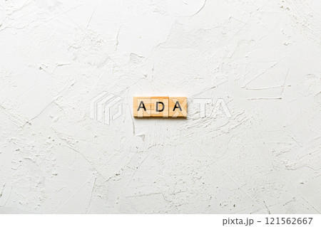 ADA word written on wood block. ADA text on table, concept 121562667