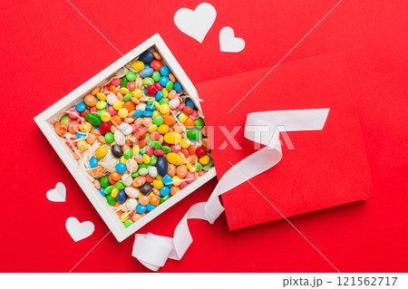 Valentine day composition: sweet candy, with gift boxes with bow and red felt hearts, photo template, background. Top View with copy space 121562717