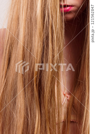 Sad girl covers her face with long hair 121562847