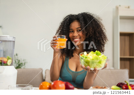 Fit woman enjoys healthy fruit breakfast after yoga training. fitness, nutrition, home lifestyle. Fit woman enjoys healthy fruit breakfast after yoga training. fitness, nutrition, home lifestyle. 121563441