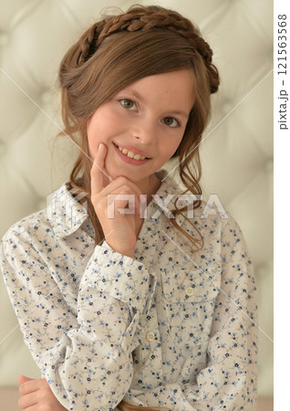 Pretty little girl poses beautifully at home 121563568