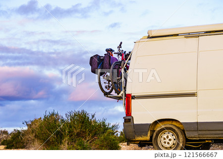 Camper van with bicycles on back rack. 121566667