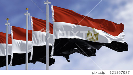 National flags of Egypt waving in the wind on a clear day National flags of Egypt waving in the wind on a clear day 121567087