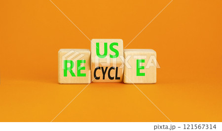 Reuse or recycle symbol. Concept words Reuse Recycle on wooden block. Beautiful orange table orange background. Business reuse or recycle concept. Copy space. 121567314