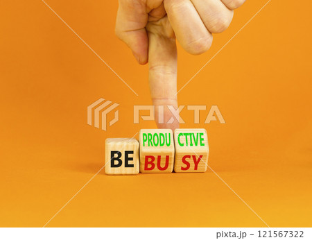 Be productive not busy symbol. Concept words Be productive Be busy on wooden block. Beautiful orange table orange background. Businessman hand. Business be productive not busy concept. Copy space. 121567322