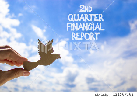 2nd quarter financial report symbol. Concept words 2nd quarter financial report. Beautiful blue sky and clouds background. Businessman hand. Business 2nd quarter financial report concept. Copy space. 121567362