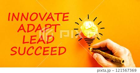 Innovate adapt lead succeed symbol. Concept words Innovate Adapt Lead Succeed on beautiful paper. Beautiful orange background. Businessman hand. Business innovate adapt lead succeed concept Copy space 121567369
