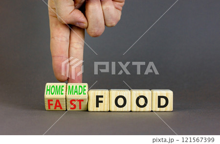 Fast or homemade food symbol. Concept words Fastfood or Homemade food on wooden cubes. Beautiful grey table grey background. Doctor hand. Healthy lifestyle Fast or homemade food concept. Copy space. Fast or homemade food symbol. Concept words Fastfood or Homemade food on wooden cubes. Beautiful grey table grey background. Doctor hand. Healthy lifestyle Fast or homemade food concept. Copy space. 121567399