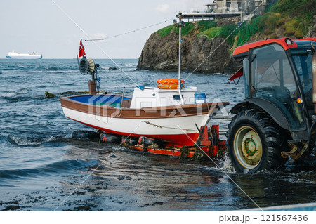unloading the boat on the shore. pulling the boat to the beach for repairs 121567436