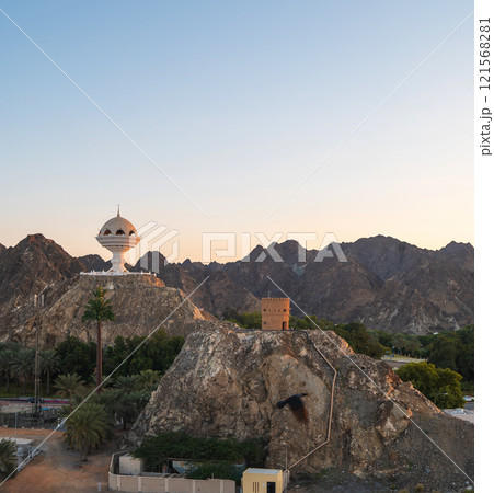 Riyam Incense Burner Monument in Muscat, Oman at Sunset with Mountainous Backdrop Riyam Incense Burner Monument in Muscat, Oman at Sunset with Mountainous Backdrop 121568281