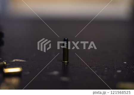 A bullet is sitting on a table A bullet is sitting on a table 121568525