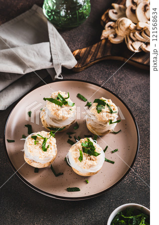 Snack of mushrooms, funchose and fish caviar on a plate on the table vertical view Snack of mushrooms, funchose and fish caviar on a plate on the table vertical view 121568634