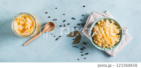 Homemade fermented cabbage in a bowl on the table top view web banner Homemade fermented cabbage in a bowl on the table top view web banner 121568656