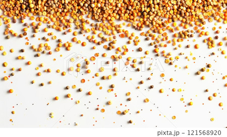 Bee pollen granules spread on a white background. Beekeeping product rich in nutrients. Concept of health supplement, natural apiculture product, and wellness. Banner. Copy space. 121568920