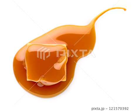caramel candy in melted caramel sauce 121570392