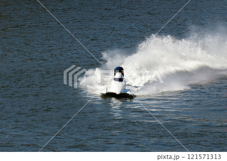 White Speedboat Making Turn on Water White Speedboat Making Turn on Water 121571313