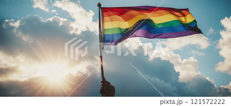 A rainbow flag wave in the wind against a cloudy sky, a sign of peace, new beginnings and change. A sign of tolerance and acceptance of the diversity of life forms 121572222