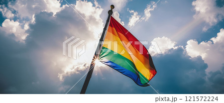 A rainbow flag wave in the wind against a cloudy sky, a sign of peace, new beginnings and change. A sign of tolerance and acceptance of the diversity of life forms 121572224