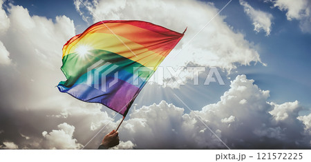 A rainbow flag wave in the wind against a cloudy sky, a sign of peace, new beginnings and change. A sign of tolerance and acceptance of the diversity of life forms 121572225