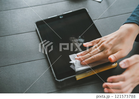 タブレット端末の画面を拭く女性 121573788