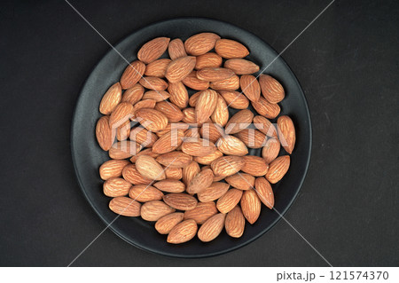 Good quality almonds in black plate Good quality almonds in black plate 121574370
