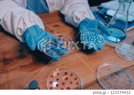 Blood test in the laboratory. Laboratory assistant working with the dispenser. Vacuum tubes with blood. Blood test in the laboratory. Laboratory assistant working with the dispenser. Vacuum tubes with blood. 121574412