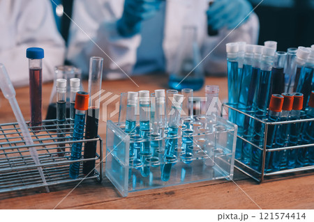 Blood test in the laboratory. Laboratory assistant working with the dispenser. Vacuum tubes with blood. Blood test in the laboratory. Laboratory assistant working with the dispenser. Vacuum tubes with blood. 121574414