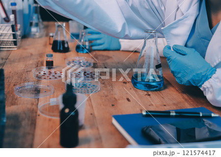 Blood test in the laboratory. Laboratory assistant working with the dispenser. Vacuum tubes with blood. Blood test in the laboratory. Laboratory assistant working with the dispenser. Vacuum tubes with blood. 121574417
