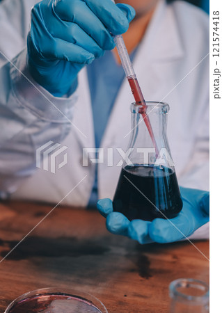 Blood test in the laboratory. Laboratory assistant working with the dispenser. Vacuum tubes with blood. Blood test in the laboratory. Laboratory assistant working with the dispenser. Vacuum tubes with blood. 121574418
