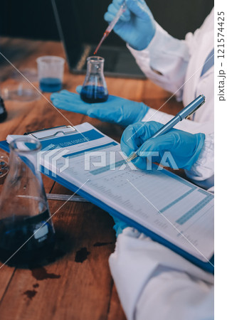 Blood test in the laboratory. Laboratory assistant working with the dispenser. Vacuum tubes with blood. Blood test in the laboratory. Laboratory assistant working with the dispenser. Vacuum tubes with blood. 121574425