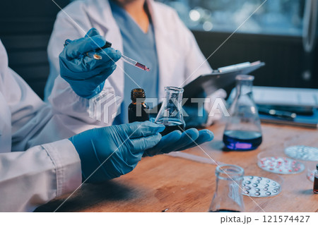 Blood test in the laboratory. Laboratory assistant working with the dispenser. Vacuum tubes with blood. 121574427