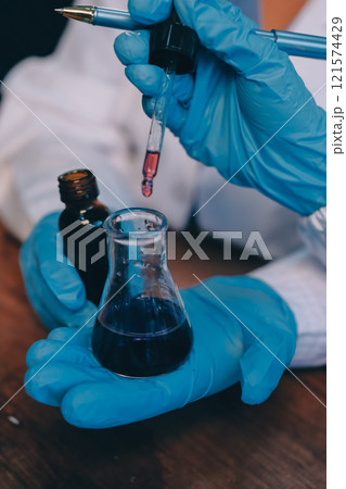 Blood test in the laboratory. Laboratory assistant working with the dispenser. Vacuum tubes with blood. Blood test in the laboratory. Laboratory assistant working with the dispenser. Vacuum tubes with blood. 121574429