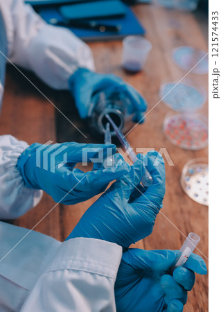 Blood test in the laboratory. Laboratory assistant working with the dispenser. Vacuum tubes with blood. Blood test in the laboratory. Laboratory assistant working with the dispenser. Vacuum tubes with blood. 121574433