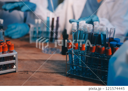 Blood test in the laboratory. Laboratory assistant working with the dispenser. Vacuum tubes with blood. 121574445