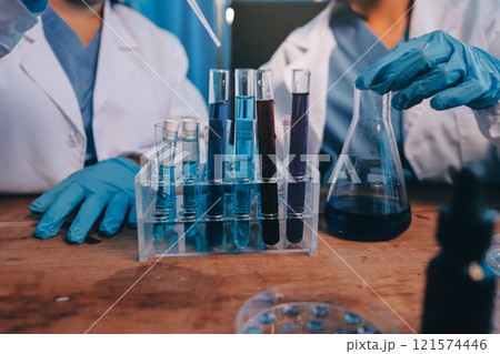 Blood test in the laboratory. Laboratory assistant working with the dispenser. Vacuum tubes with blood. 121574446