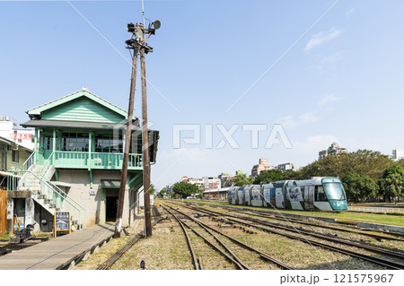 The circular light rail train drives past the former Kaohsiung Port Station North Signal Box, Taiwan. The circular light rail train drives past the former Kaohsiung Port Station North Signal Box, Taiwan. 121575967