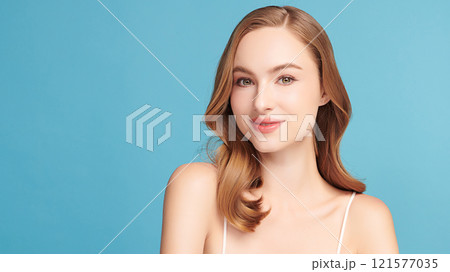 Beautiful young woman with clean fresh skin on blue background, Face care, Facial treatment, Cosmetology, beauty and spa, women portrait. Beautiful young woman with clean fresh skin on blue background, Face care, Facial treatment, Cosmetology, beauty and spa, women portrait. 121577035