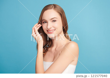 Beautiful young woman with clean fresh skin on blue background, Face care, Facial treatment, Cosmetology, beauty and spa, women portrait. 121577040
