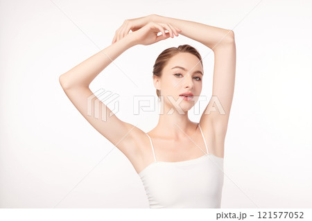 Beautiful Young woman lifting hands up to show off clean and hygienic armpits or underarms on white background, Smooth armpit cleanliness and protection concept 121577052