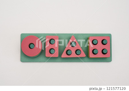 A wooden logic game made of shapes with holes. child development. on a white background 121577120