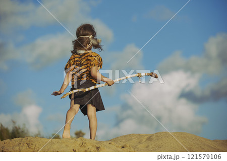 Cute baby dressed in the clothes of primitive people 121579106