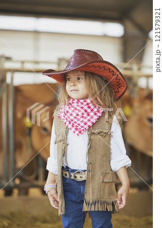 Charming child in a cowboy costume on a cows farm in Denmark 121579321