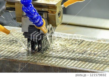 The EDM machine working with liquid coolant method. 121579692