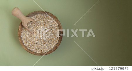 Fine ground barley in green background copy space Whole spelt grain species. High protein fiber-rich vegan plant based food ingredient. Gluten free superfood healthy nutritional dietary alternative Fine ground barley in green background copy space Whole spelt grain species. High protein fiber-rich vegan plant based food ingredient. Gluten free superfood healthy nutritional dietary alternative 121579973
