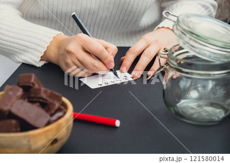 Step by step instruction of making handmade Christmas advent sweet candies delicious calendar. Female hands creating craft homemade decor. New year celebration 121580014