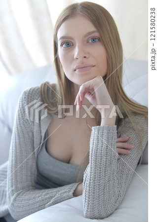 Beauty portrait. Young woman on grey wall background. 121580238