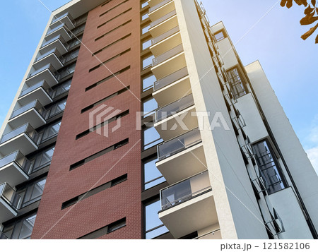 View of multi-storey buildings in a modern residential complex on a sunny day a blue sky background. Skyscrapers and real estate 121582106