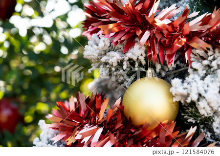 Background of gold decoration ball on christmas tree with another ornament Background of gold decoration ball on christmas tree with another ornament 121584076